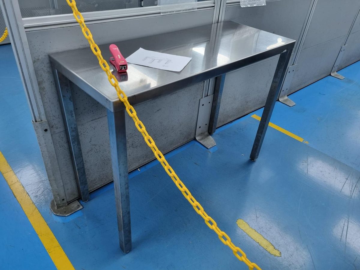 Slim cleanroom stainless steel bench with square legs against a partition wall on an ESD floor in Singapore