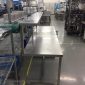Long stainless steel production bench with overshelf riser in a Singapore cleanroom assembly area